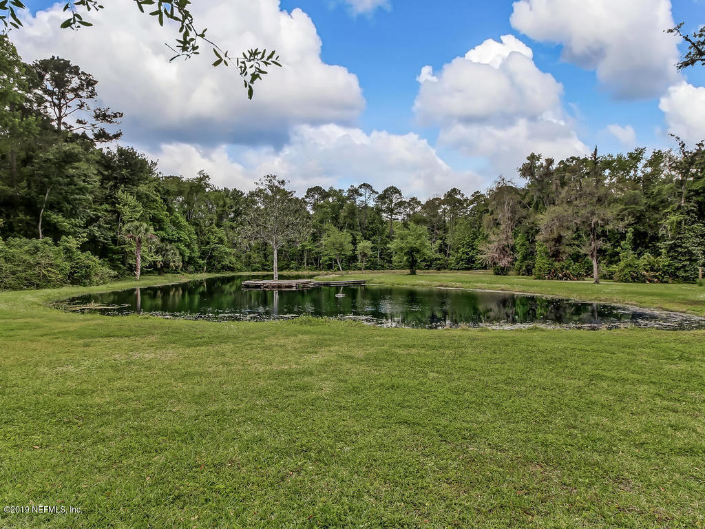 86051 Ellis Estates Landing Road Yulee, FL 32097 - Photo 32 of 35 a view of a lake with houses in the back