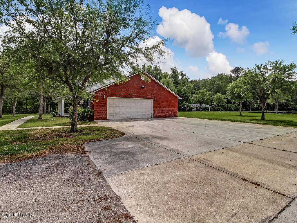 86051 Ellis Estates Landing Road Yulee, FL 32097 - Photo 34 of 35 a front view of a house with a yard