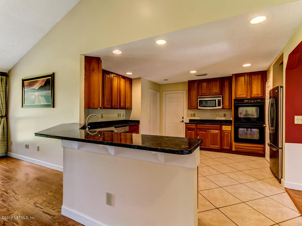 86051 Ellis Estates Landing Road Yulee, FL 32097 - Photo 6 of 35 a kitchen with stainless steel appliances granite countertop a sink and a stove top oven