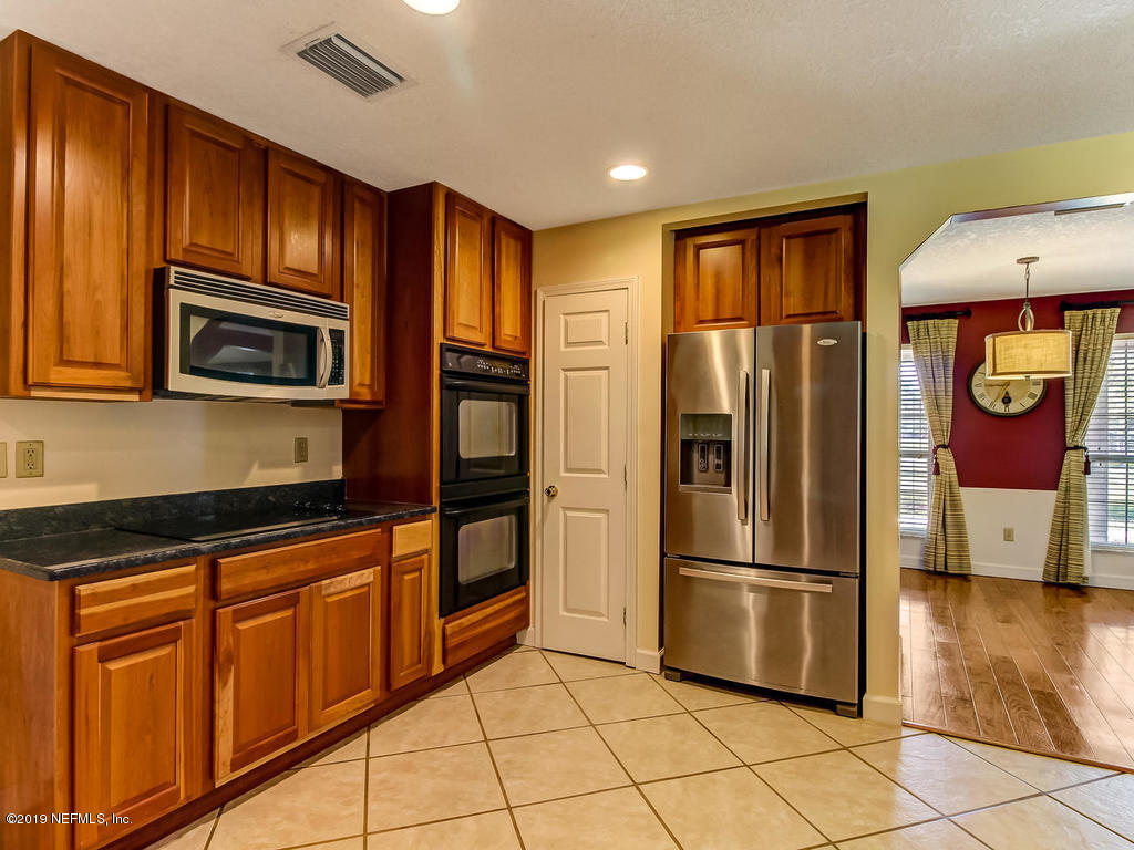 86051 Ellis Estates Landing Road Yulee, FL 32097 - Photo 7 of 35 a kitchen with stainless steel appliances granite countertop a refrigerator and microwave