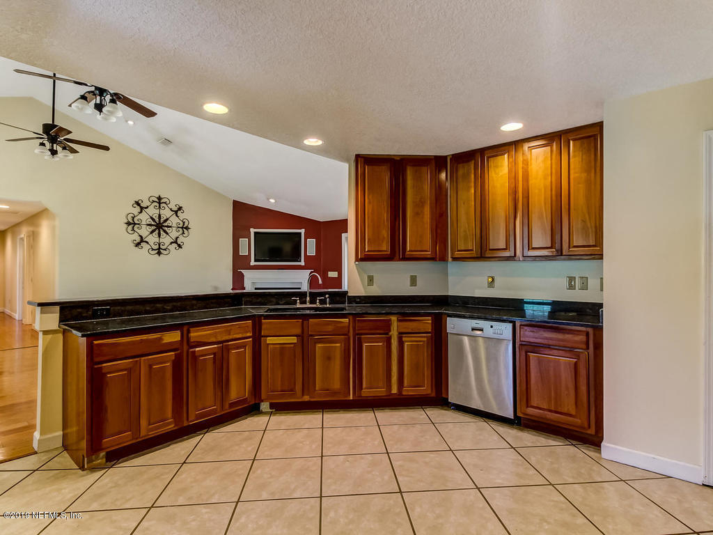 86051 Ellis Estates Landing Road Yulee, FL 32097 - Photo 8 of 35 a kitchen with stainless steel appliances granite countertop a stove a sink and a microwave