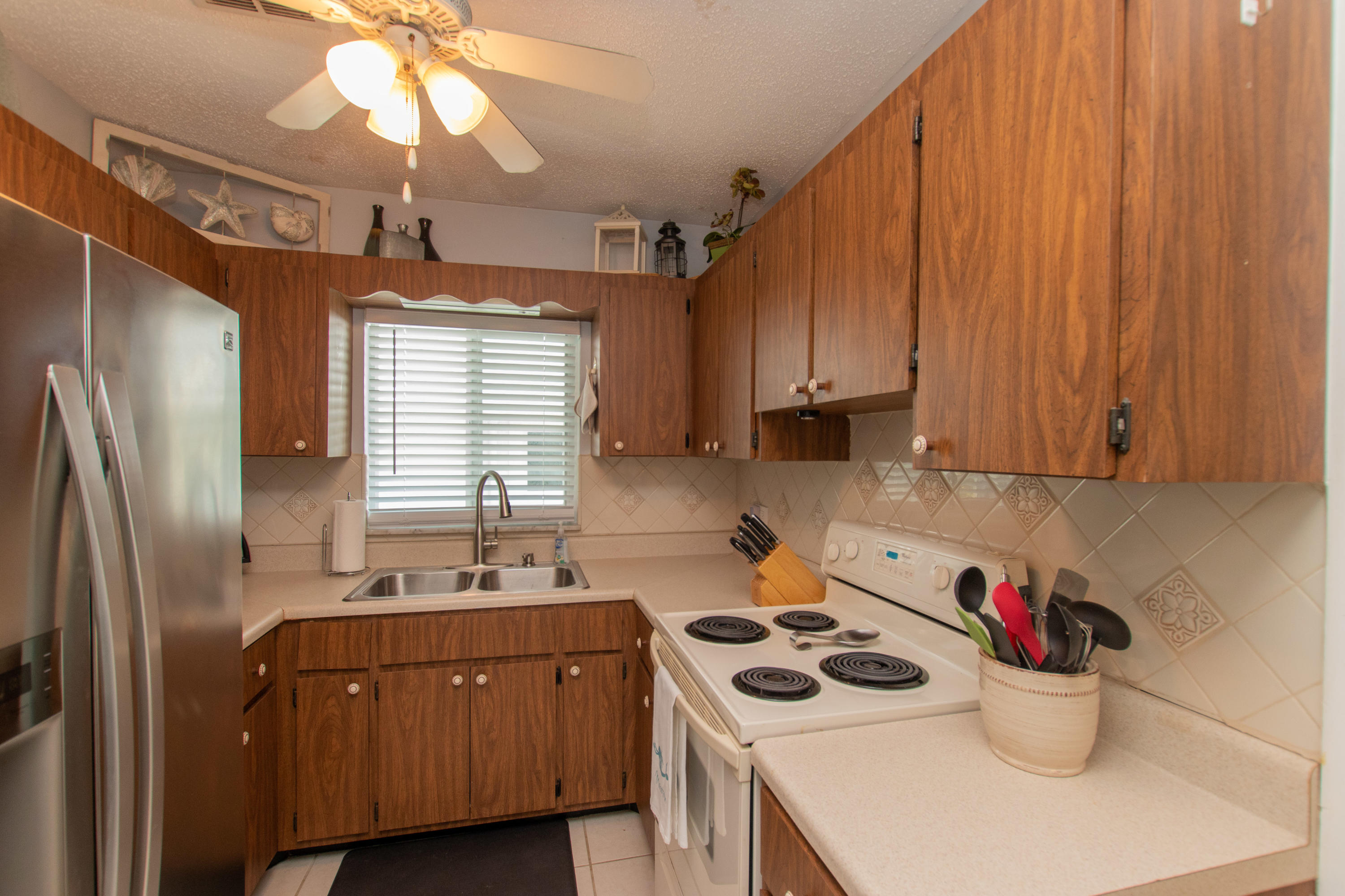 945 98th Street Marathon, FL 33050 - Photo 11 of 49 a kitchen with stainless steel appliances a stove a sink and a refrigerator