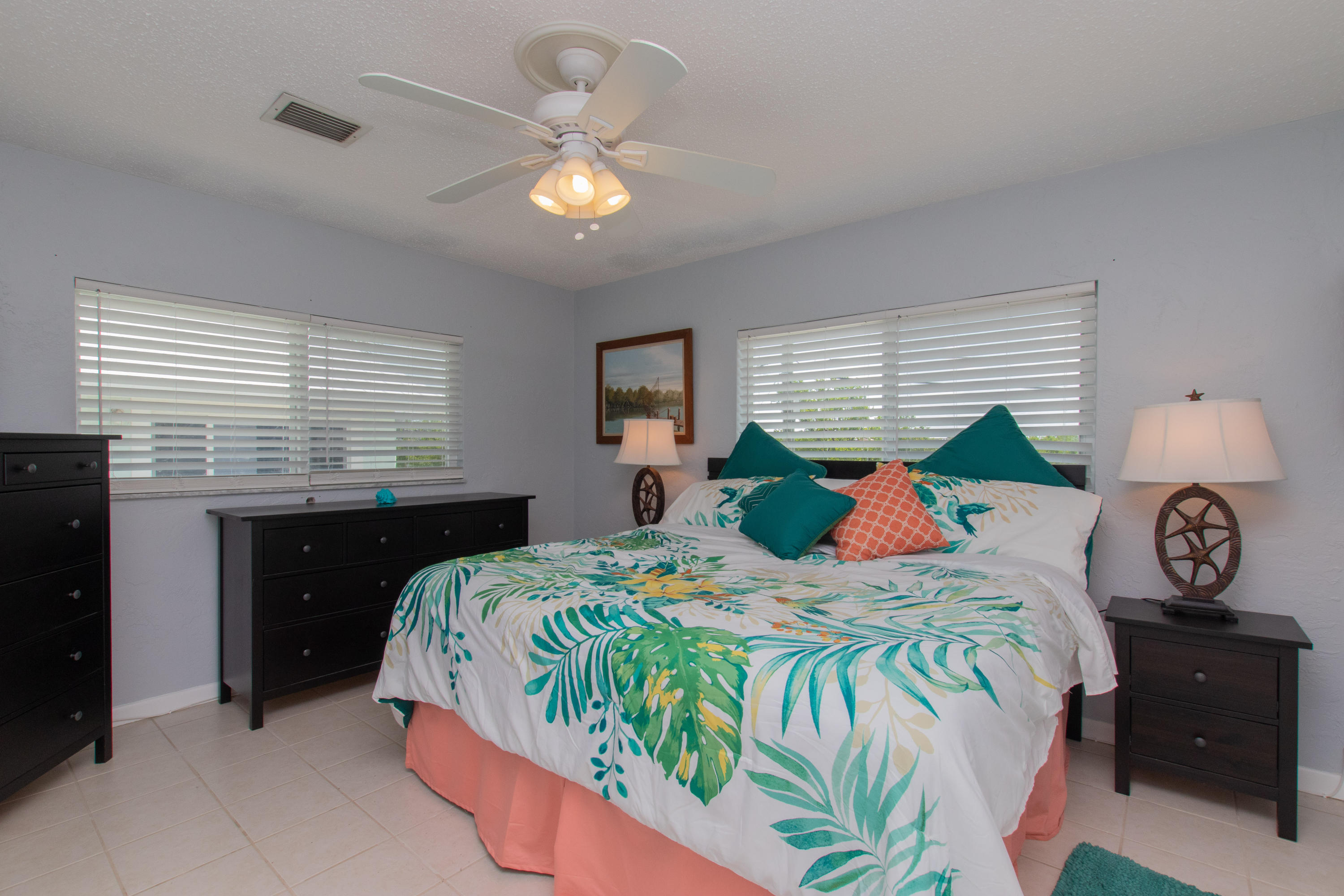 945 98th Street Marathon, FL 33050 - Photo 12 of 49 a bedroom with a bed and a chandelier