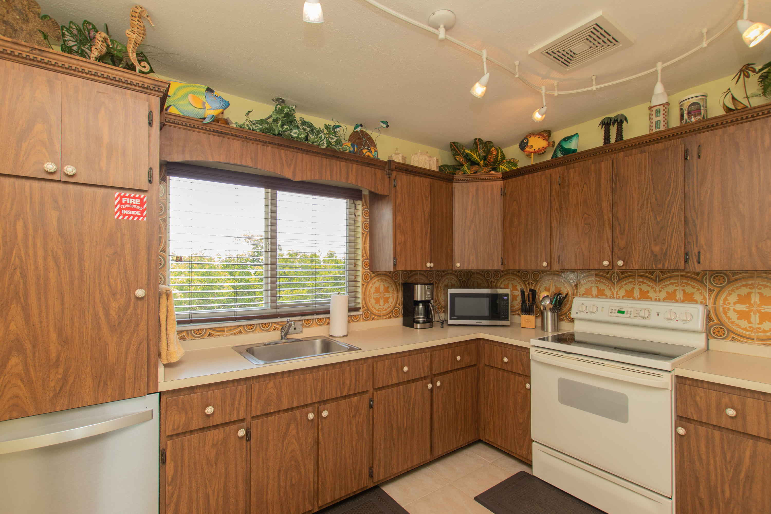945 98th Street Marathon, FL 33050 - Photo 24 of 49 a kitchen with a sink window and cabinets