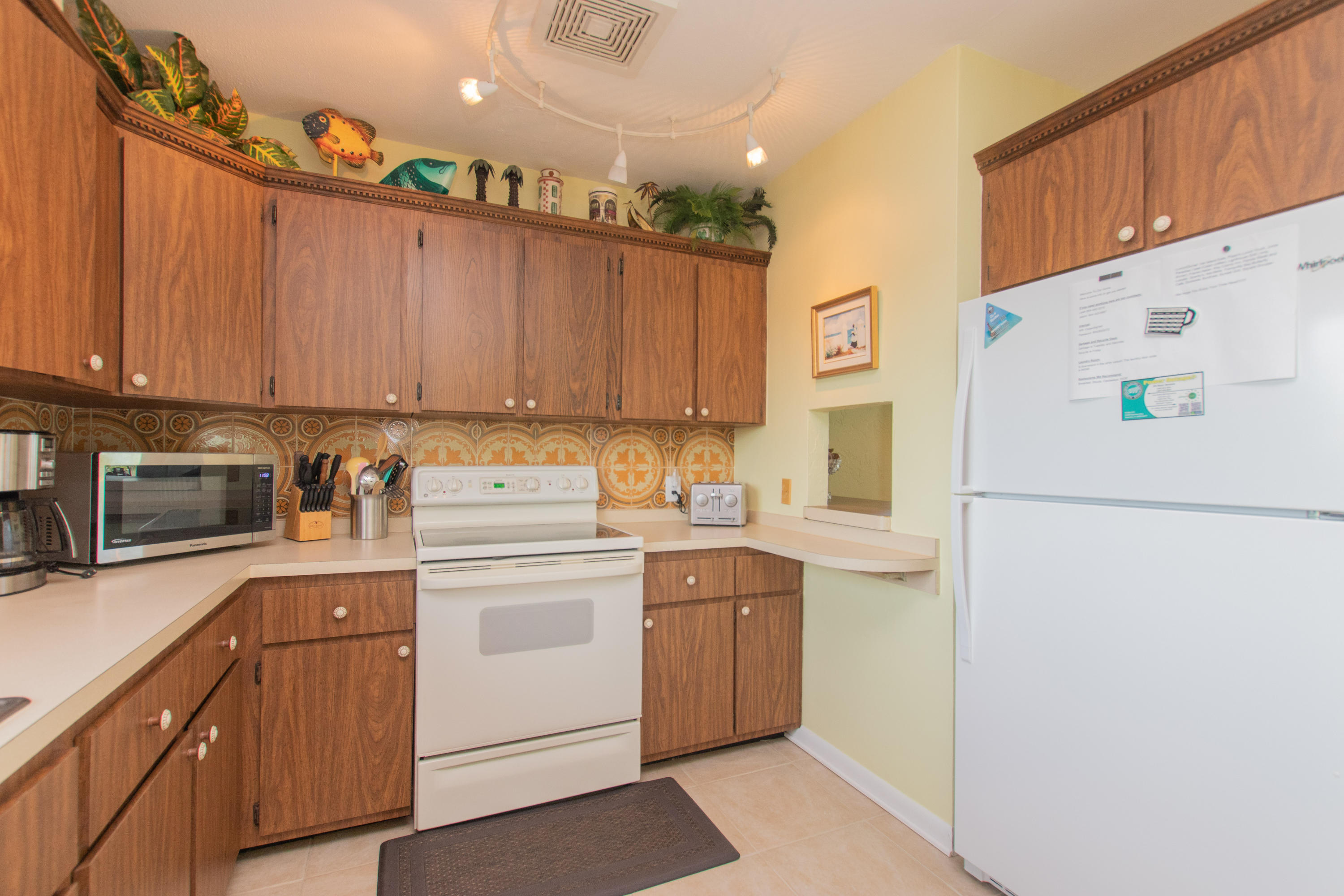 945 98th Street Marathon, FL 33050 - Photo 26 of 49 a kitchen with a refrigerator a stove a sink and cabinets
