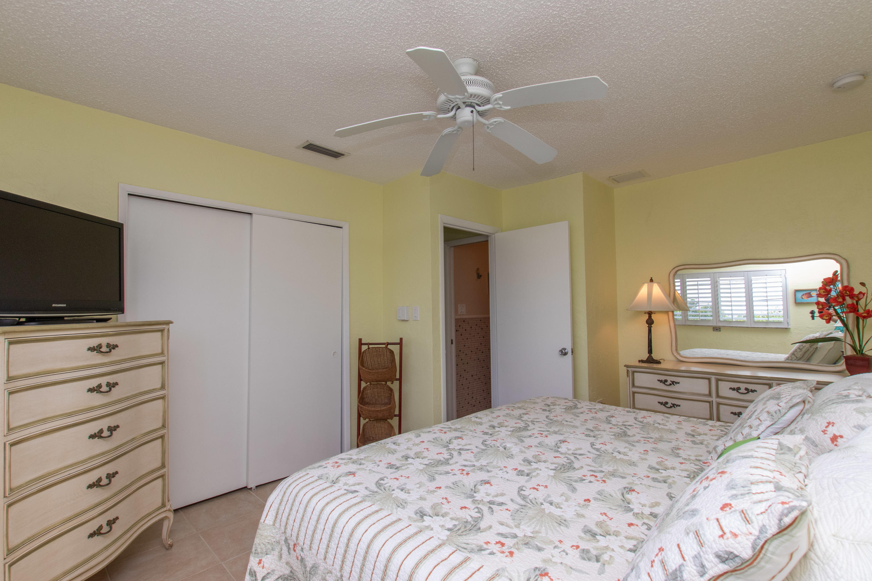 945 98th Street Marathon, FL 33050 - Photo 34 of 49 a bedroom with a bed and a flat screen tv