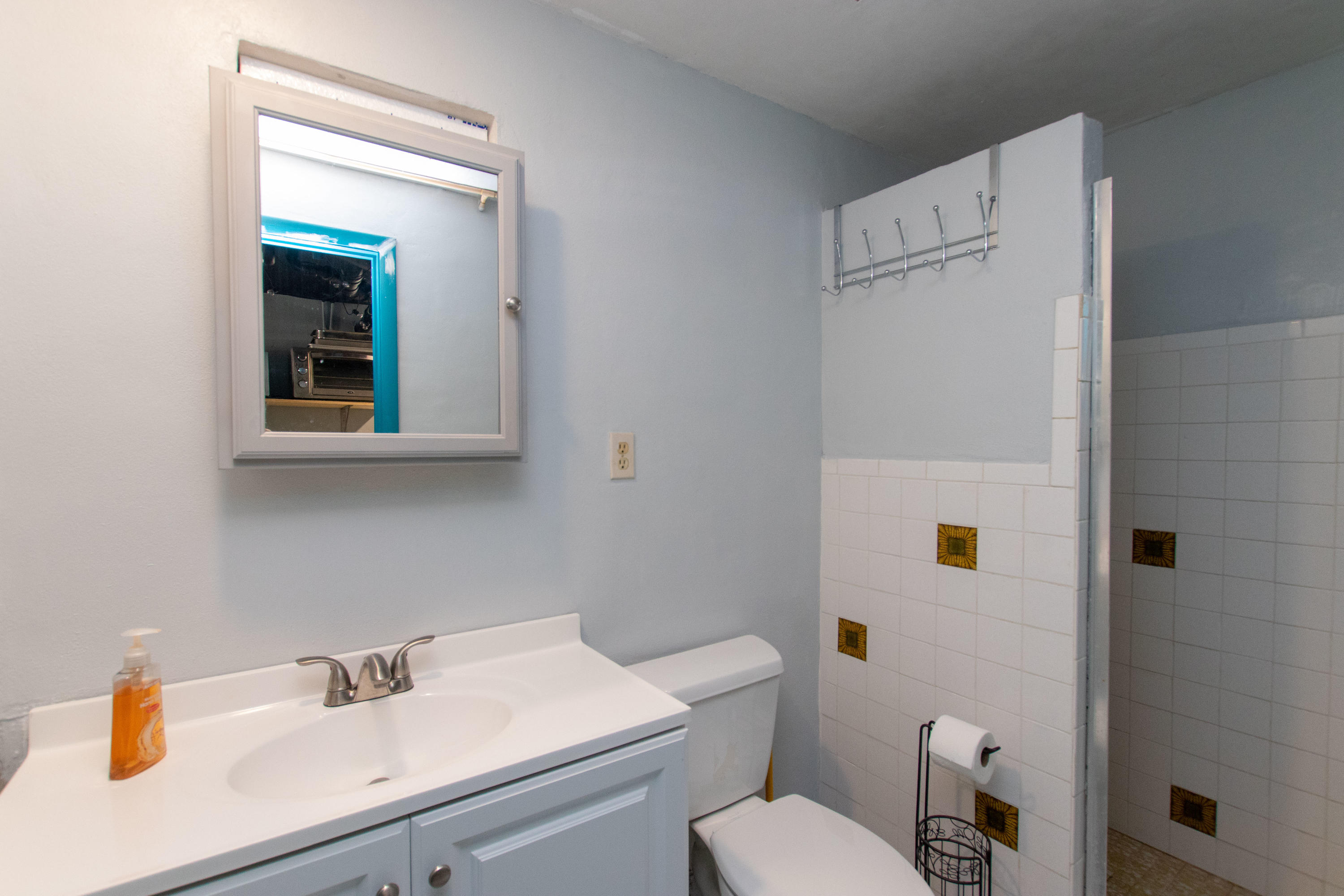 945 98th Street Marathon, FL 33050 - Photo 40 of 49 a bathroom with a sink a toilet and mirror