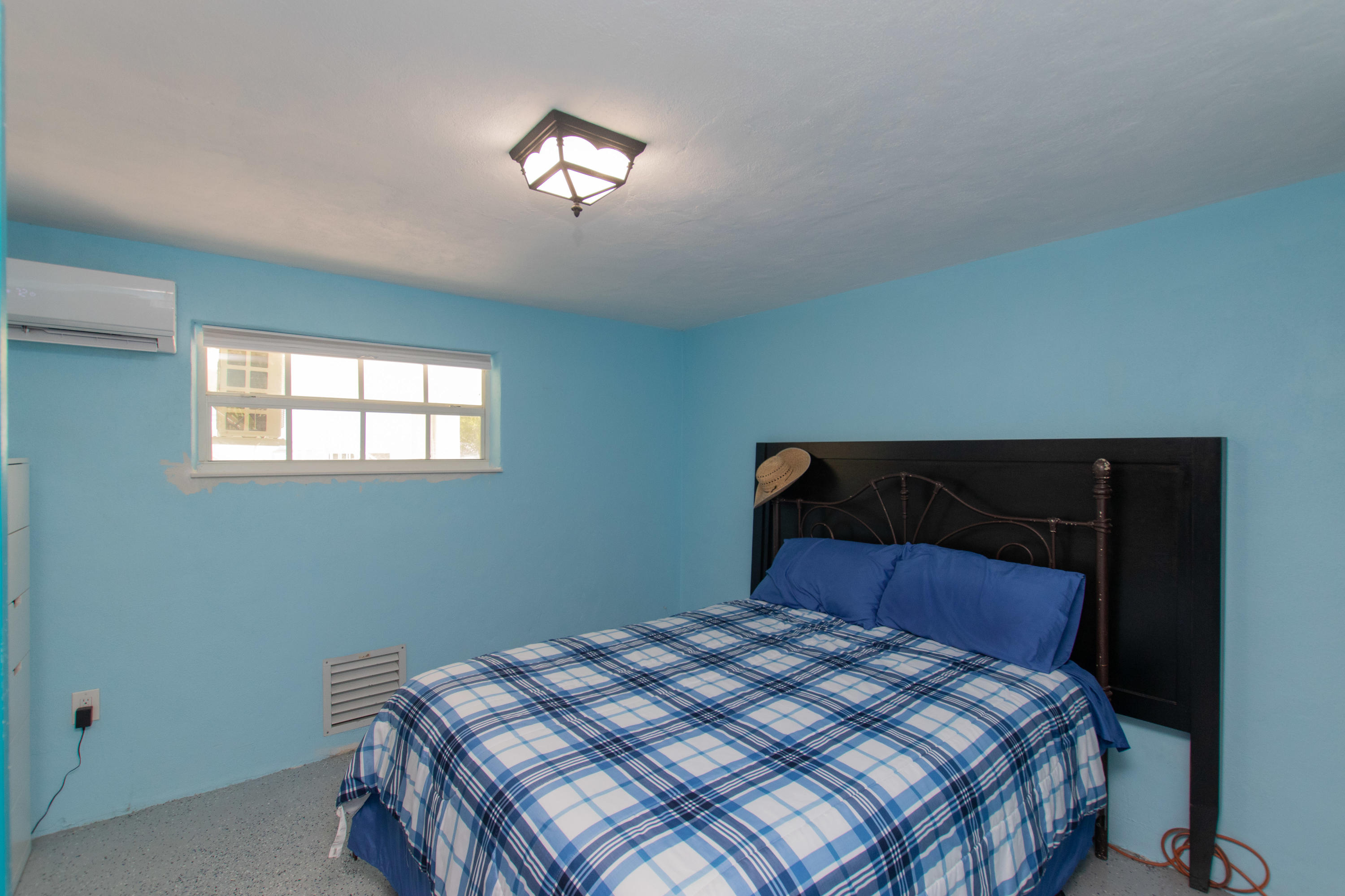 945 98th Street Marathon, FL 33050 - Photo 41 of 49 a bedroom with a bed and a window
