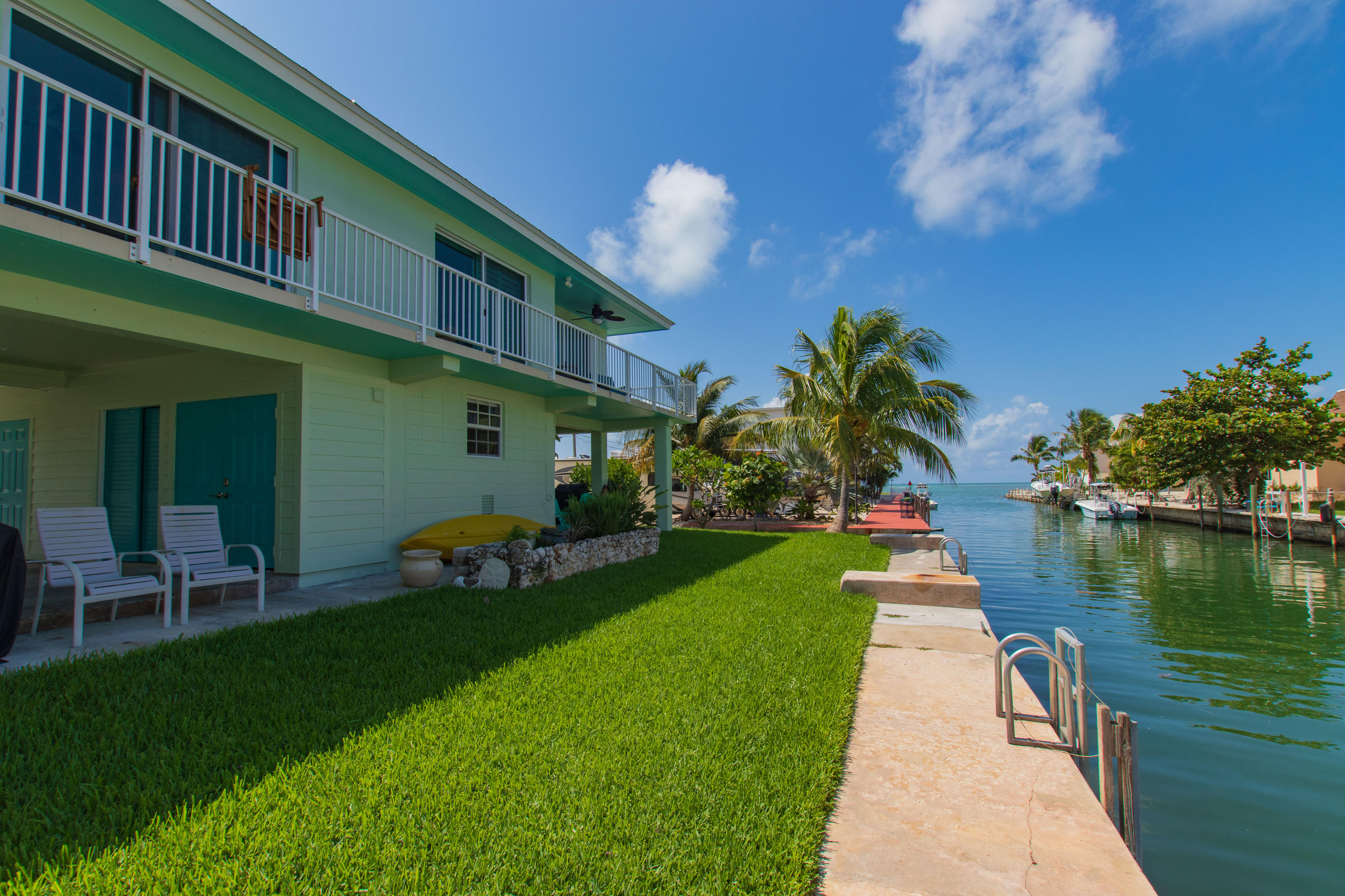 945 98th Street Marathon, FL 33050 - Photo 44 of 49 a front view of a house with a garden and lake view
