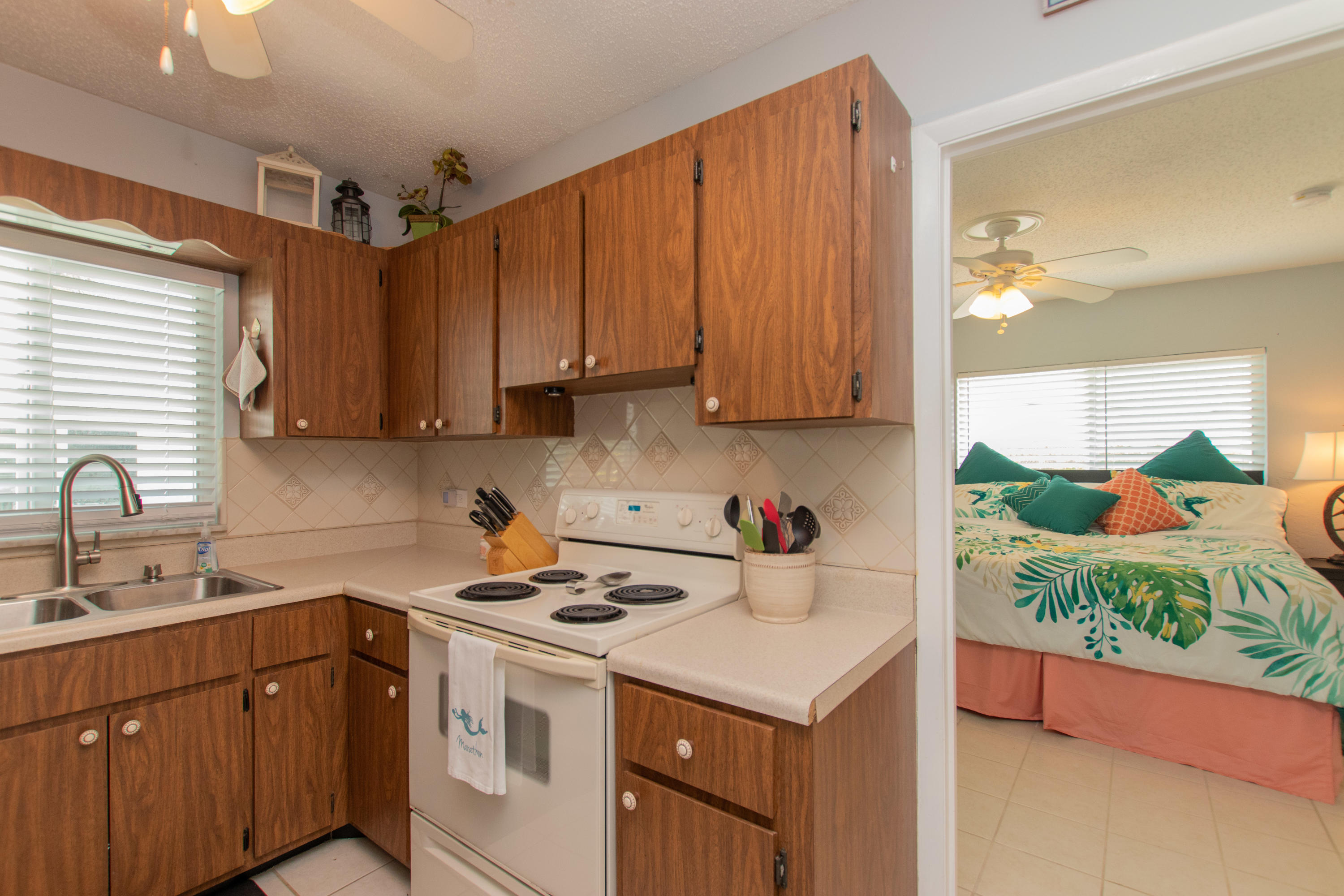 945 98th Street Marathon, FL 33050 - Photo 10 of 49 a kitchen with a sink a stove and cabinets