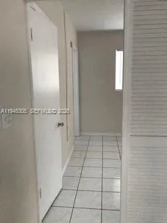 a view of a kitchen with white walls