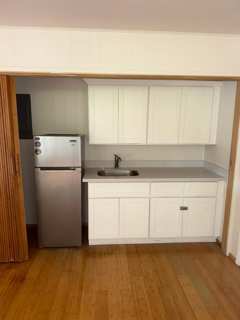 11585 McCarthy Road Carmel Valley, CA 93924 - Photo 46 of 52 a kitchen with a refrigerator and white cabinets
