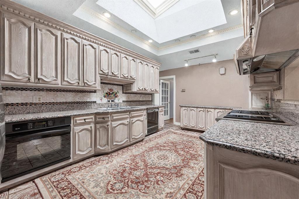 501 Colgate Drive Lancaster, TX 75134 - Photo 5 of 13 a kitchen with stainless steel appliances granite countertop a stove a sink and a microwave