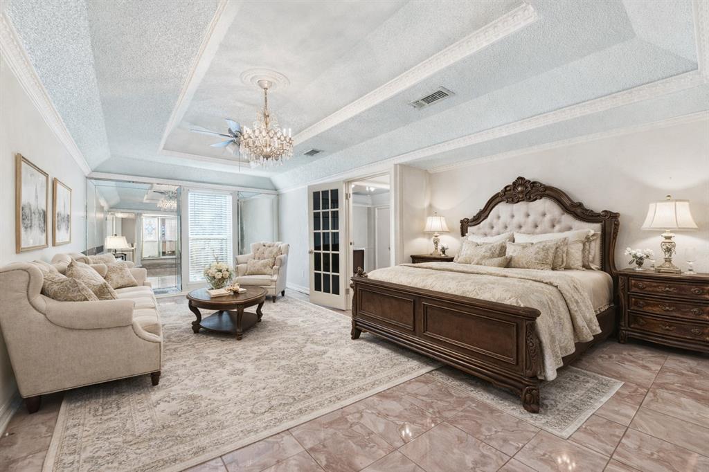 501 Colgate Drive Lancaster, TX 75134 - Photo 8 of 13 a spacious bedroom with a bed and ceiling fan