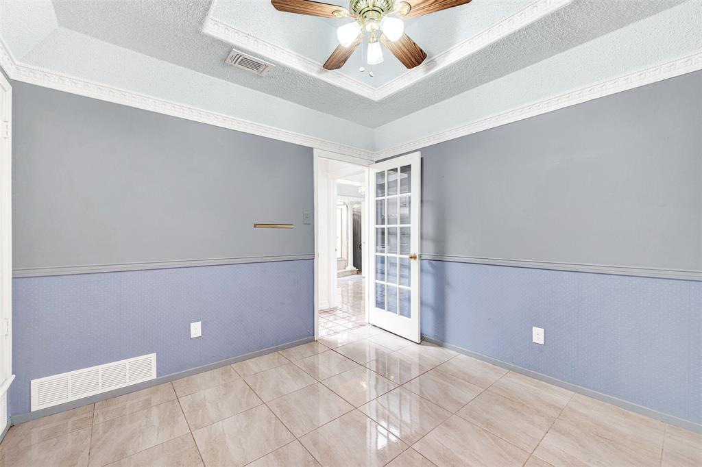 501 Colgate Drive Lancaster, TX 75134 - Photo 10 of 13 en empty room with ceiling fan and window