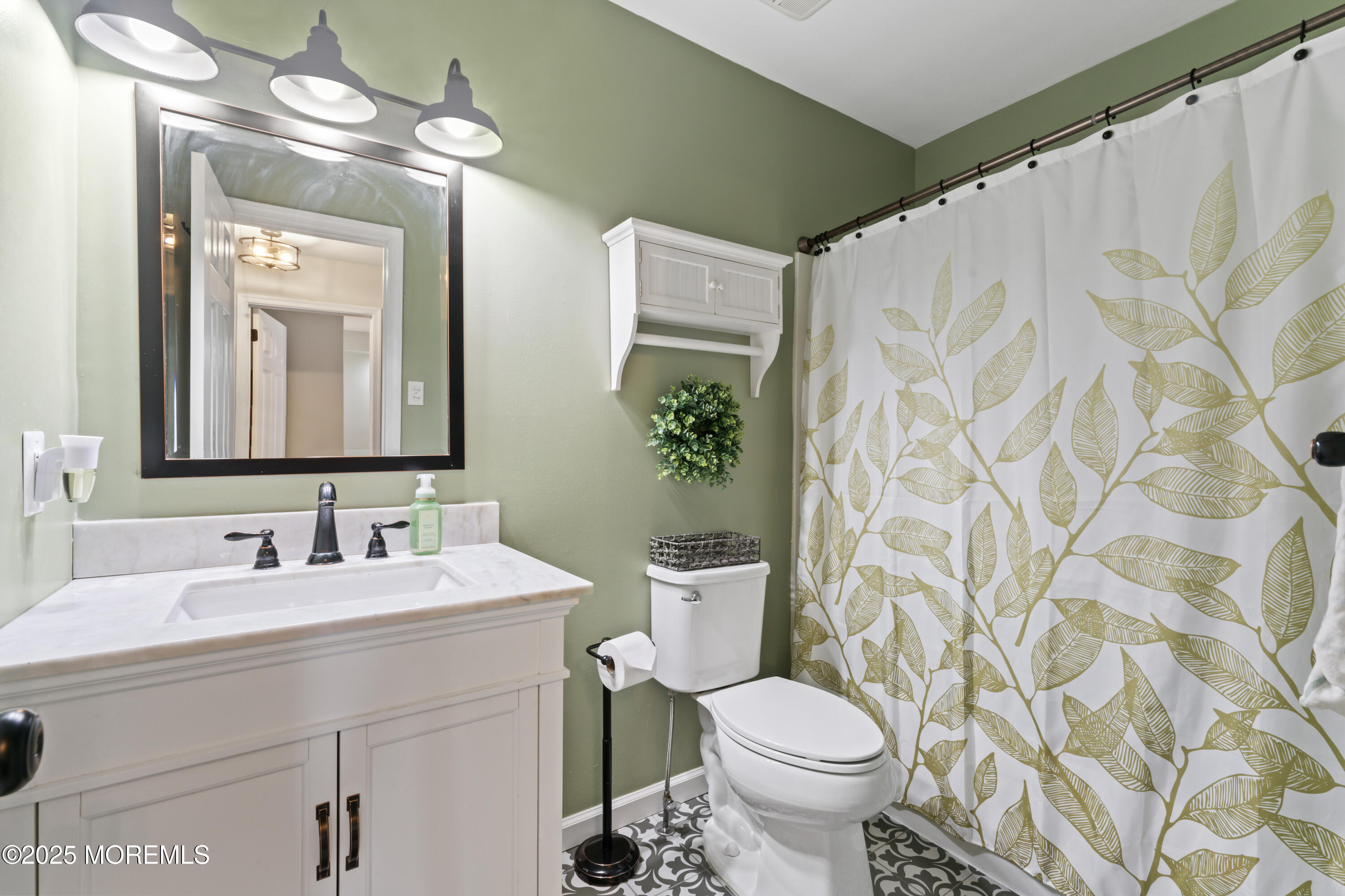 6 Blueberry Path Howell, NJ 07731 - Photo 24 of 38 a bathroom with a toilet a sink and a mirror