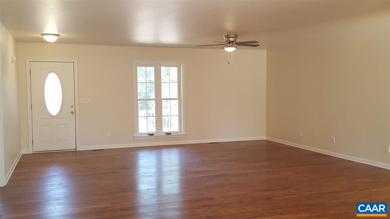 995 Bibb Store Road Louisa, VA 23093 - Photo 9 of 50 an empty room with wooden floor and mirror