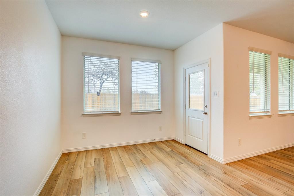 532 Ranchito Pass Haslet, TX 76052 - Photo 15 of 38 an empty room with wooden floor and windows