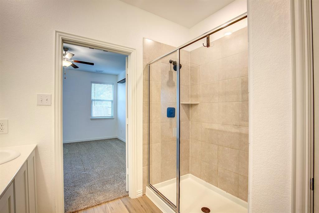532 Ranchito Pass Haslet, TX 76052 - Photo 22 of 38 a bathroom that has a glass shower door