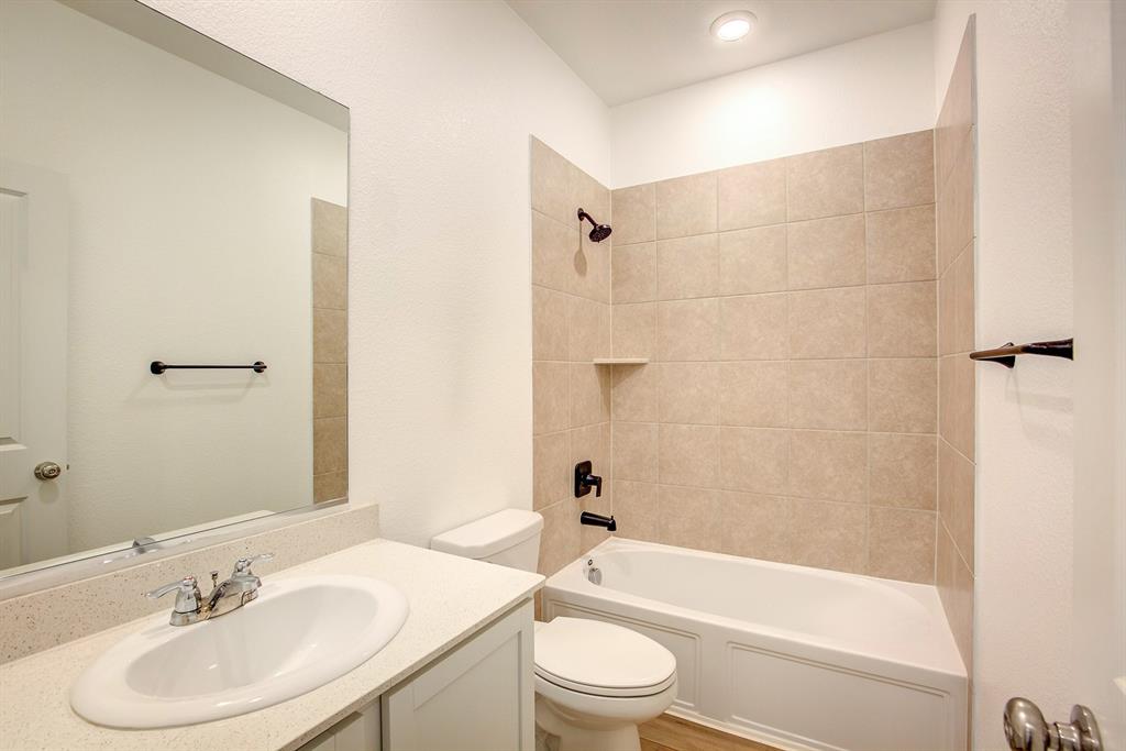 532 Ranchito Pass Haslet, TX 76052 - Photo 31 of 38 a bathroom with a bathtub shower sink and a toilet