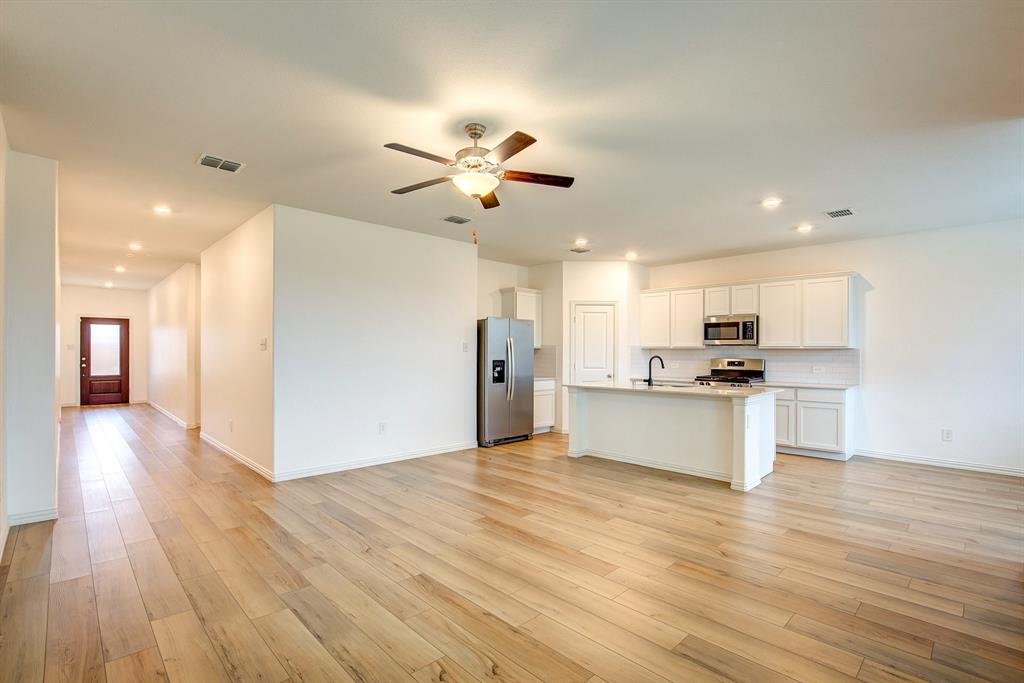 532 Ranchito Pass Haslet, TX 76052 - Photo 8 of 38 a view of kitchen with refrigerator microwave and wooden floor