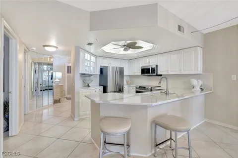 a kitchen with stainless steel appliances a sink and a refrigerator