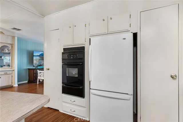 a kitchen with stainless steel appliances a refrigerator and a stove top oven