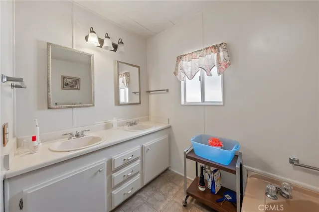 a bathroom with a sink mirror and vanity