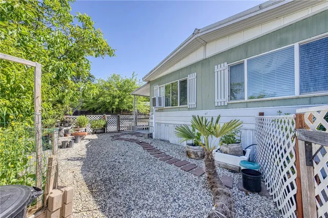 a view of a chair and table in the backyard