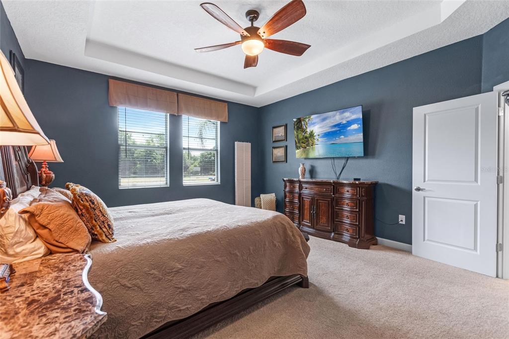 1089 Blackwolf Run Road Davenport, FL 33896 - Photo 20 of 82 a bedroom with a bed and dresser with mirror