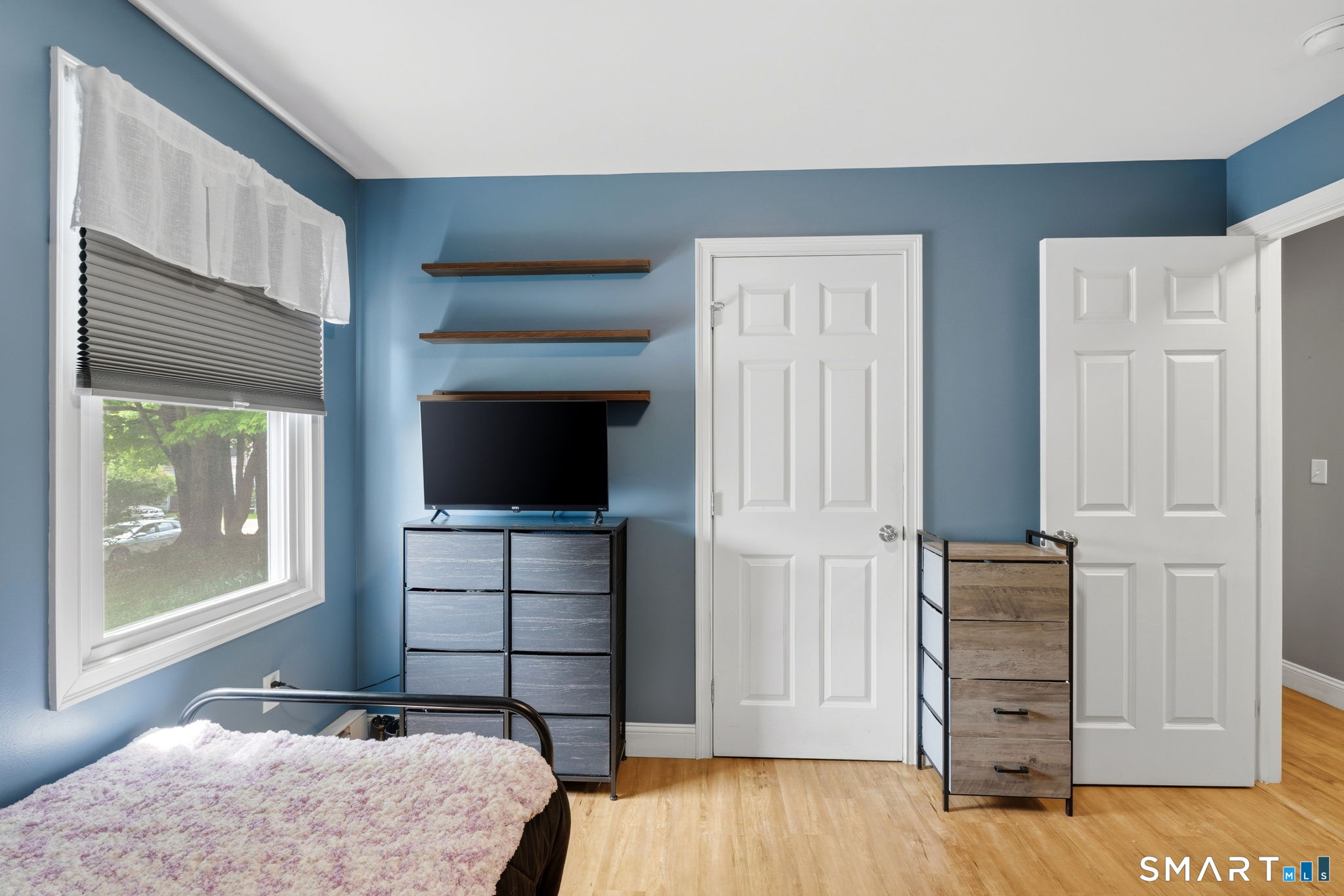 71 Smith Street Putnam, CT 06260 - Photo 9 of 25 a bedroom with a bed and wooden floor