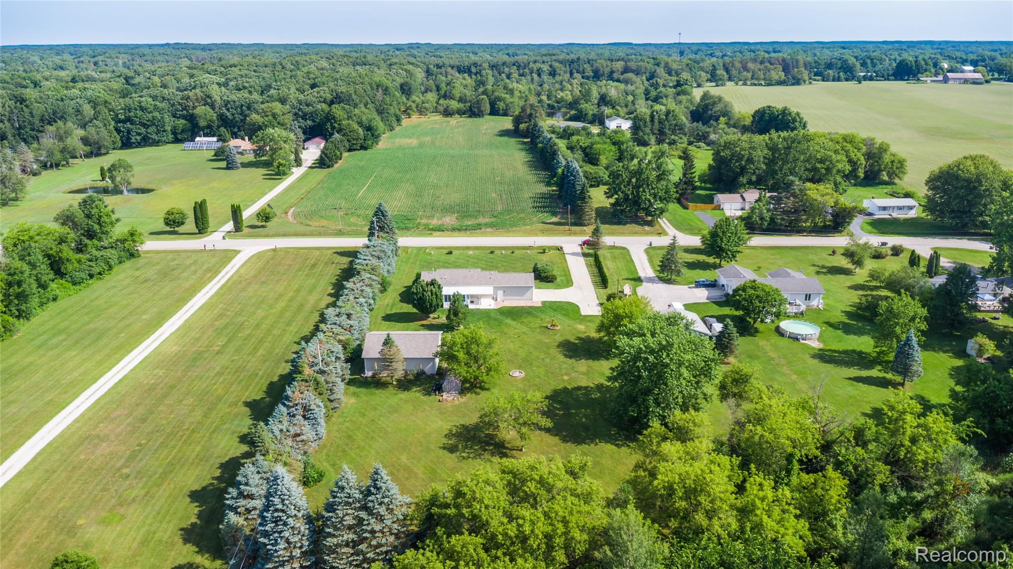 9600 Hamill Road Otisville, MI 48463 - Photo 22 of 32 Expansive rural landscape featuring extensive green space, mature trees, and agricultural fields