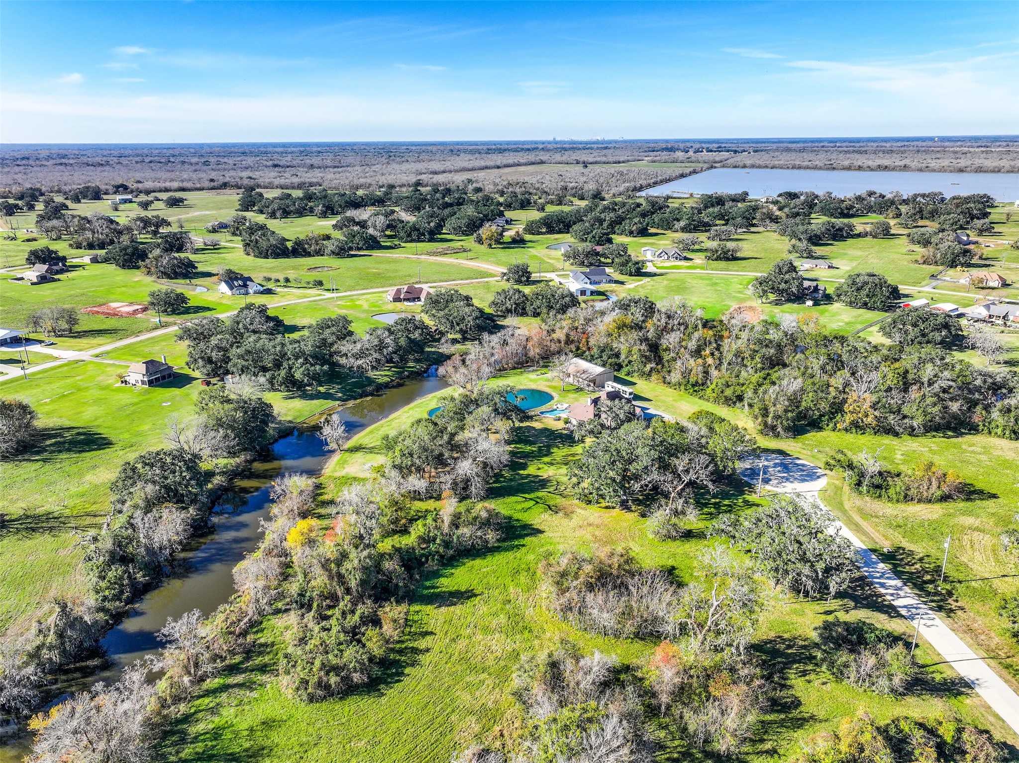 1031 Winchester Trail Angleton, TX 77515 - Photo 14 of 19 a view of a lush green field with lots of bushes