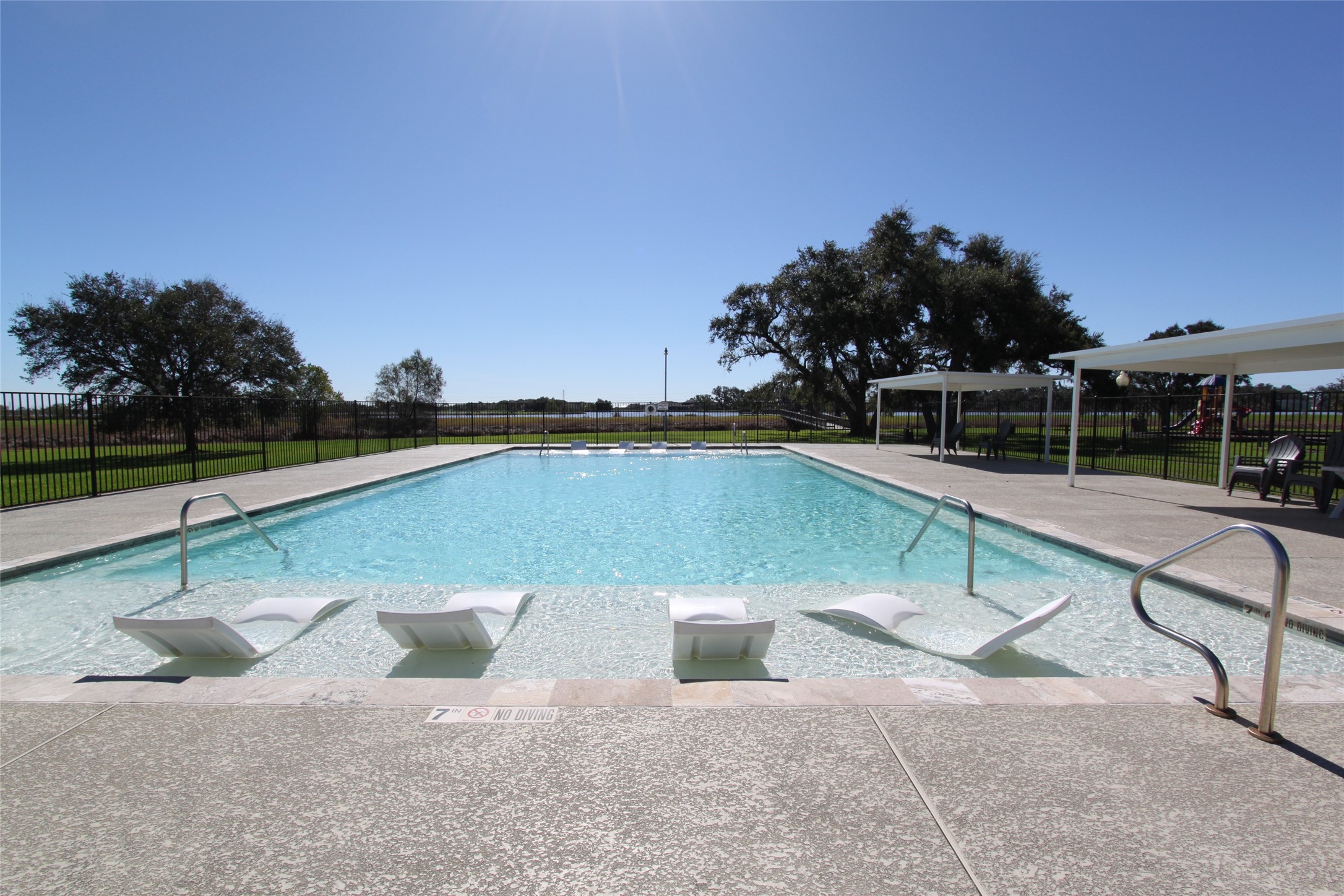 1031 Winchester Trail Angleton, TX 77515 - Photo 16 of 19 a view of a swimming pool with a lounge chair