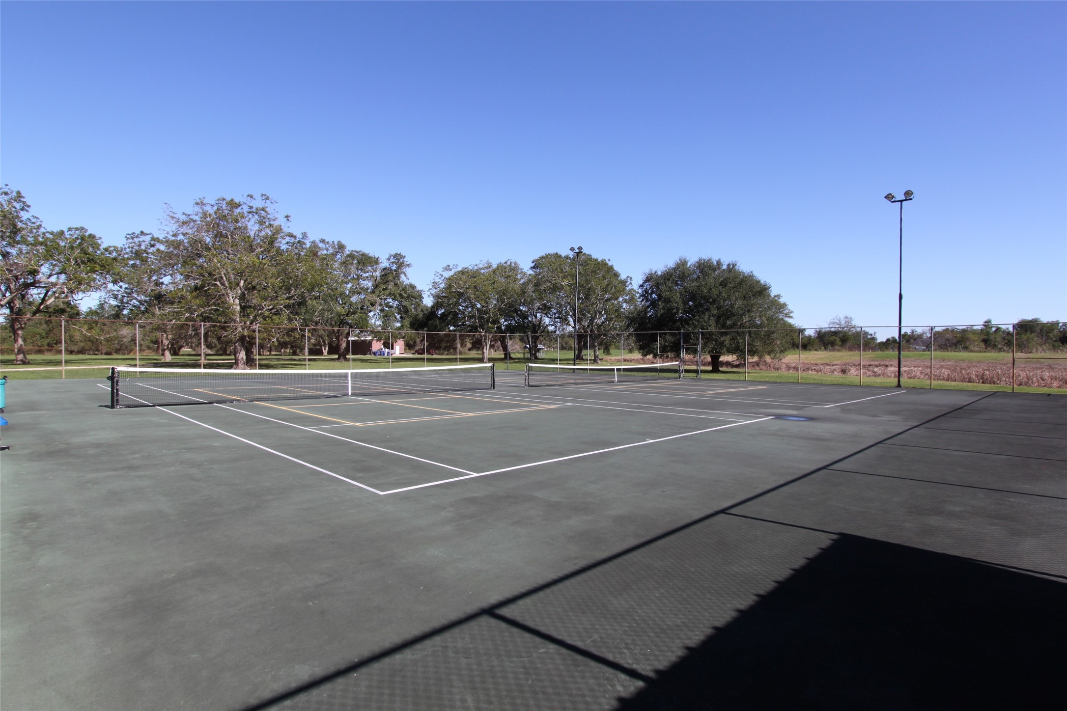 1031 Winchester Trail Angleton, TX 77515 - Photo 17 of 19 a view of a tennis court