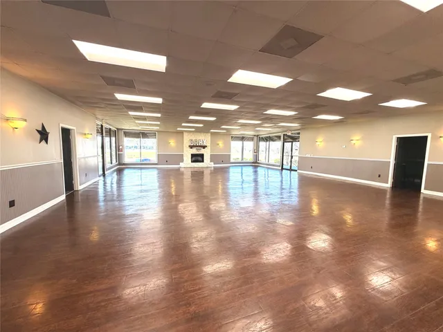 a view of a room with wooden floor