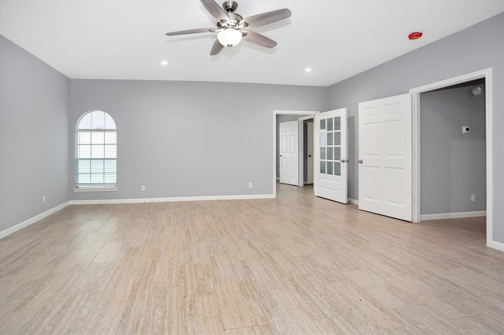 24600 Nine Bar Road Hempstead, TX 77445 - Photo 14 of 26 an empty room with wooden floor closet and windows