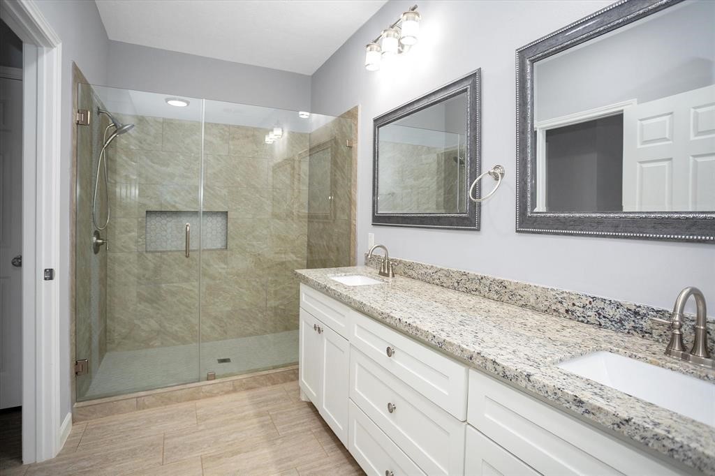24600 Nine Bar Road Hempstead, TX 77445 - Photo 15 of 26 a bathroom with a granite countertop sink mirror shower and