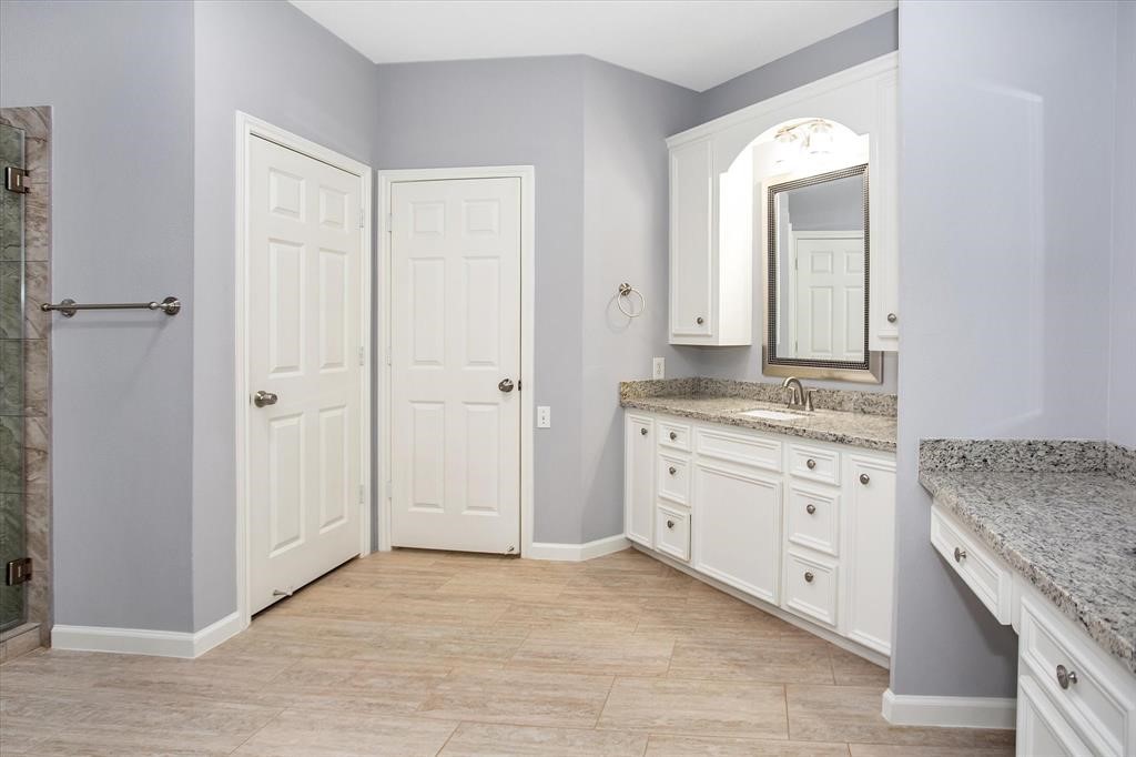 24600 Nine Bar Road Hempstead, TX 77445 - Photo 18 of 26 a bathroom with a granite countertop sink and a mirror