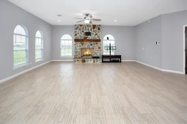 an empty room with windows and chandelier