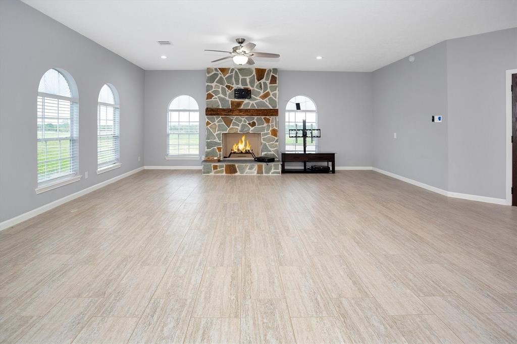24600 Nine Bar Road Hempstead, TX 77445 - Photo 7 of 26 an empty room with windows and chandelier