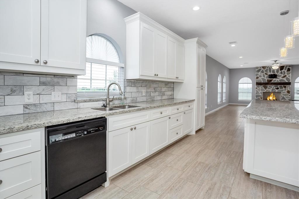 24600 Nine Bar Road Hempstead, TX 77445 - Photo 10 of 26 a kitchen with granite countertop cabinets stainless steel appliances a sink and a window