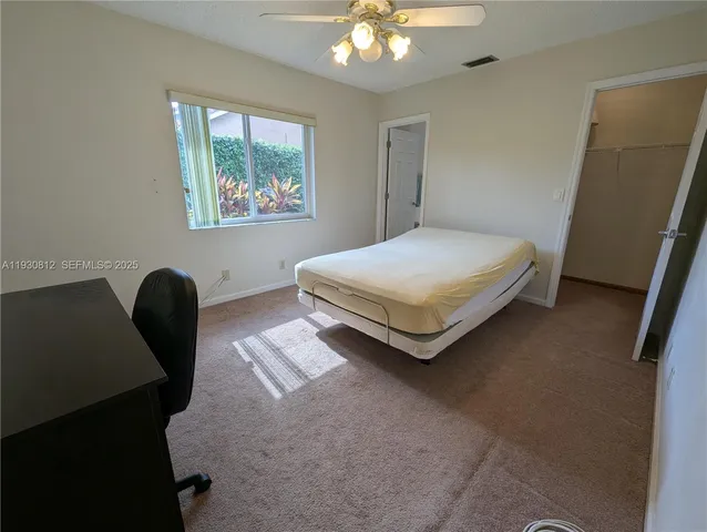 a bedroom with a bed lamp and a window