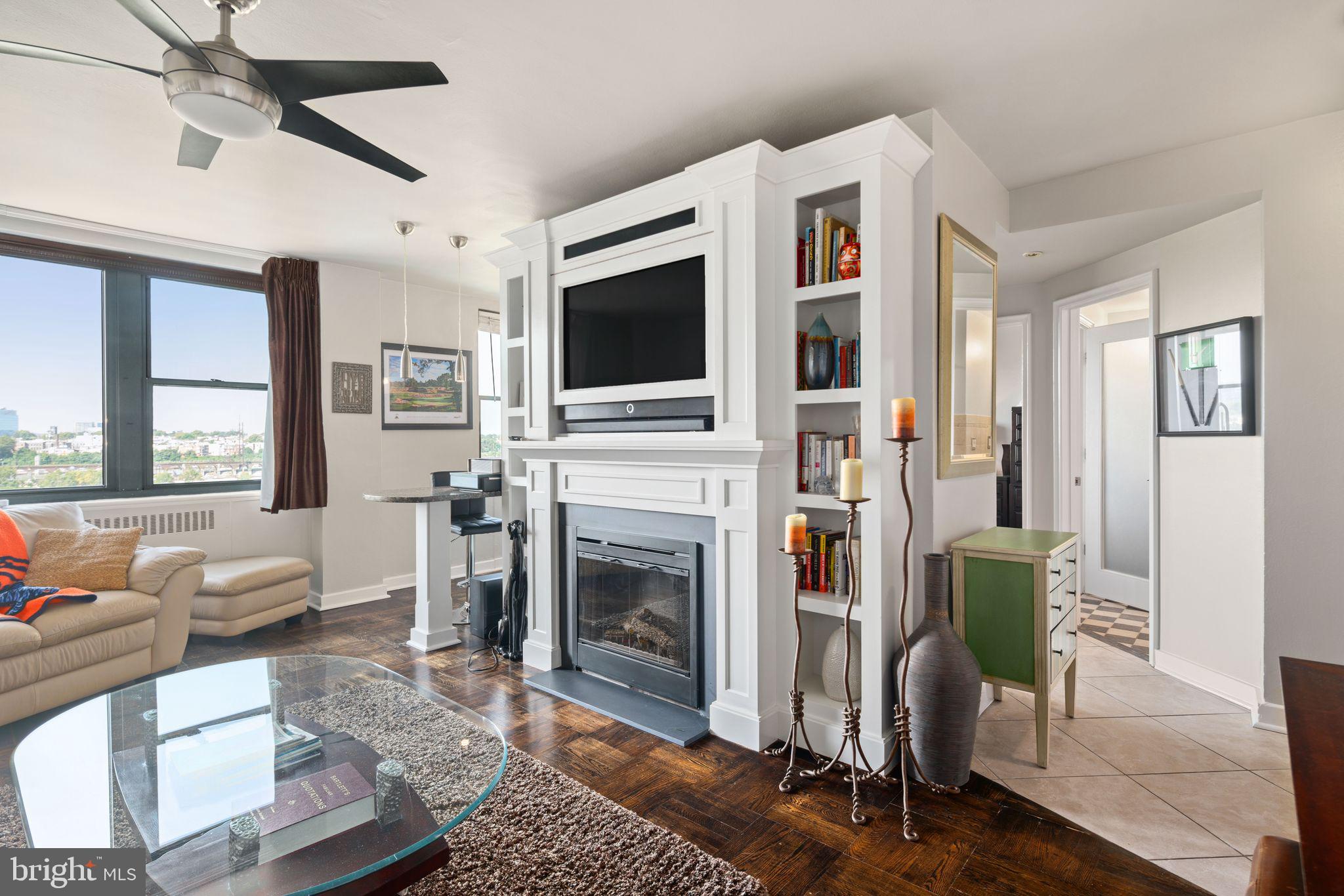 2601 Pennsylvania Avenue, Unit 846 Philadelphia, PA 19130 - Photo 1 of 40 a living room with furniture a flat screen tv and a fireplace