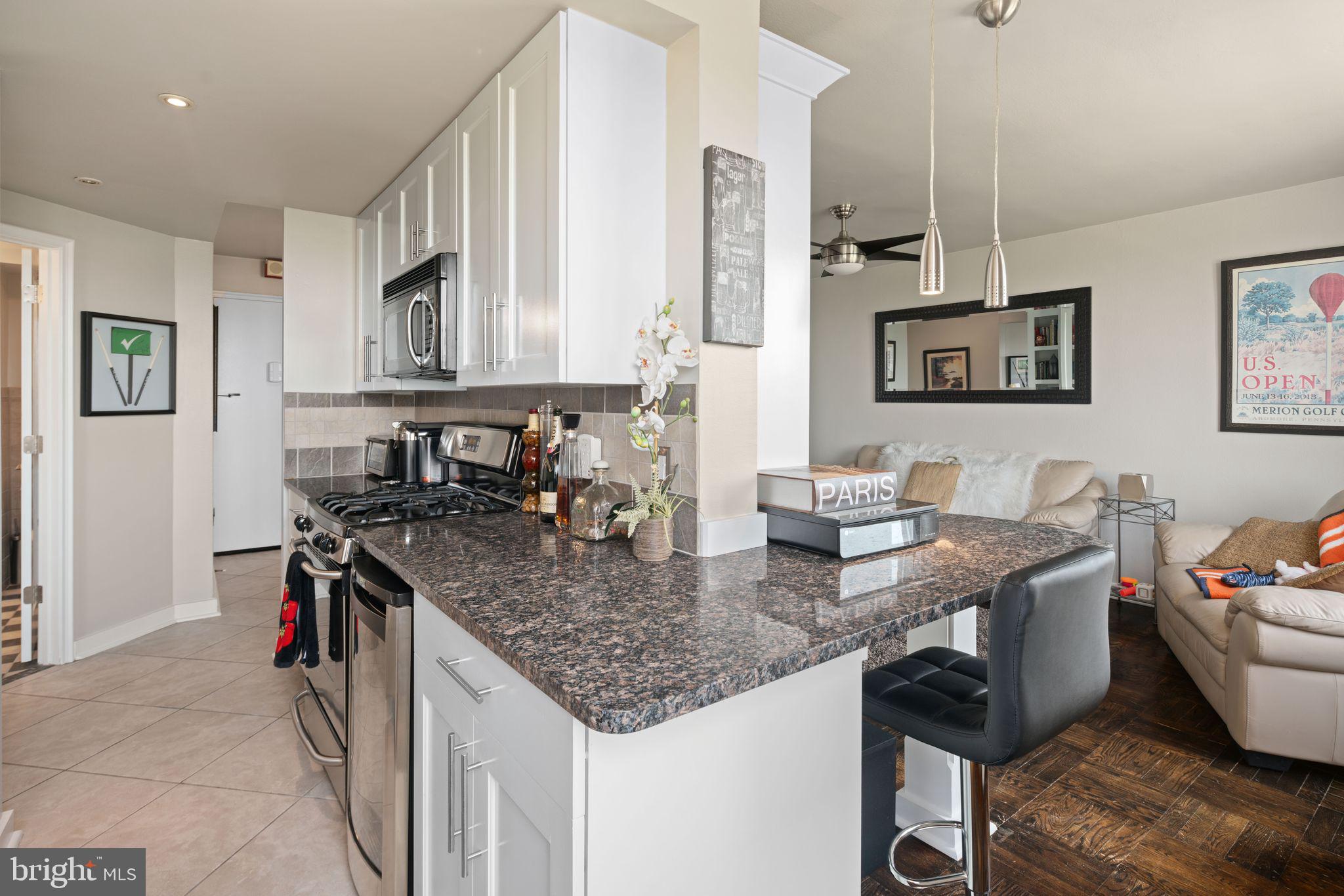 2601 Pennsylvania Avenue, Unit 846 Philadelphia, PA 19130 - Photo 13 of 40 a kitchen with stainless steel appliances granite countertop a sink stove and cabinets