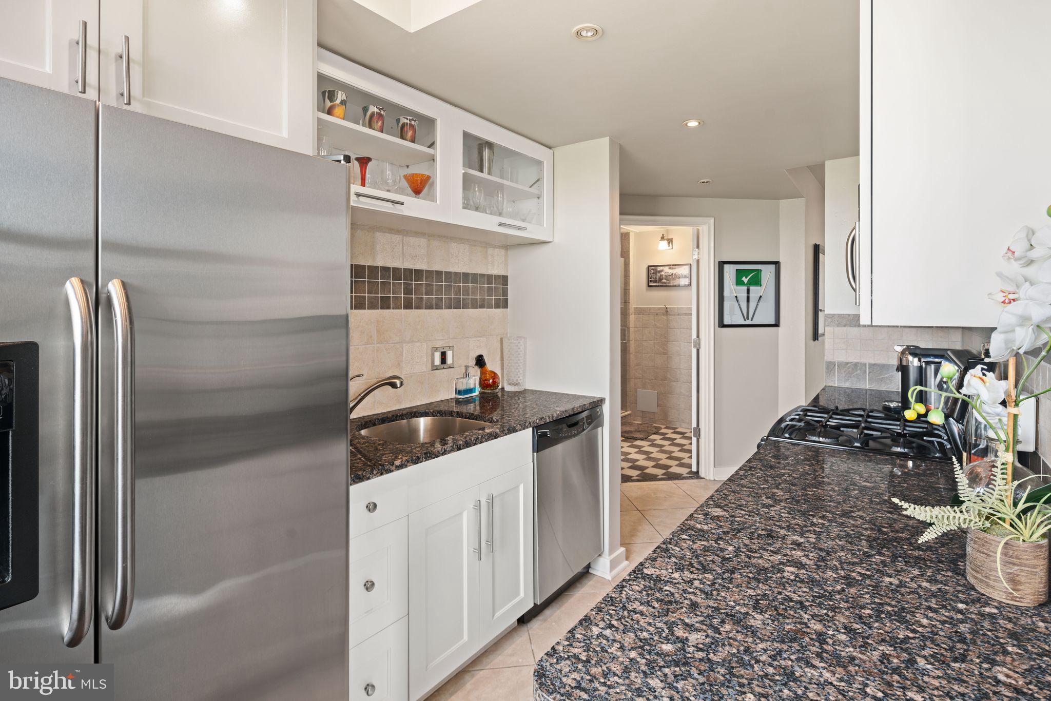 2601 Pennsylvania Avenue, Unit 846 Philadelphia, PA 19130 - Photo 16 of 40 a kitchen with stainless steel appliances granite countertop a refrigerator and a sink