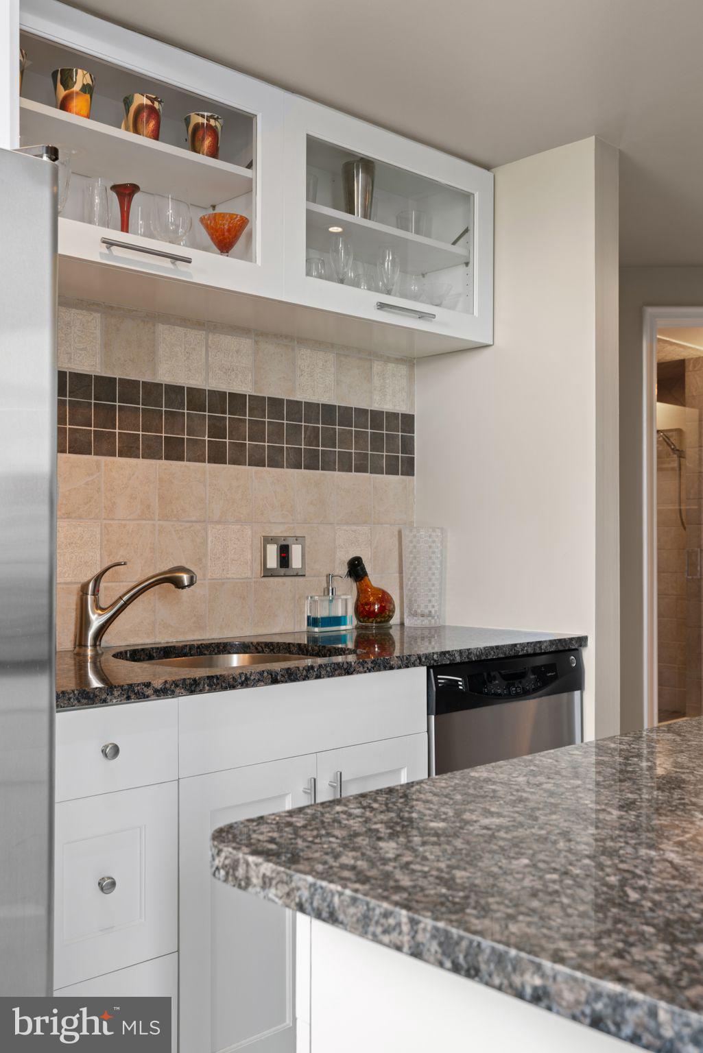 2601 Pennsylvania Avenue, Unit 846 Philadelphia, PA 19130 - Photo 17 of 40 a kitchen with granite countertop a sink and cabinets