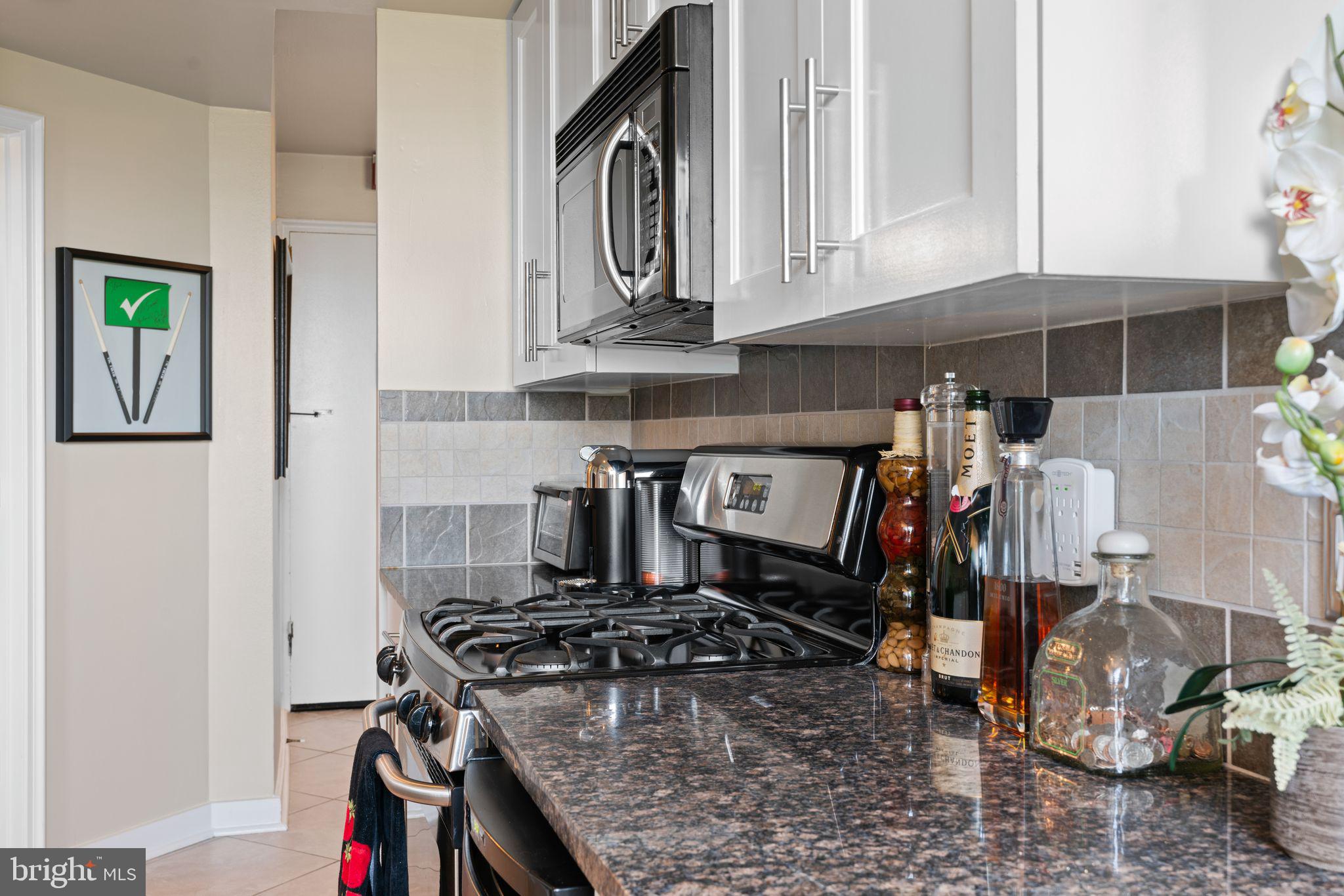 2601 Pennsylvania Avenue, Unit 846 Philadelphia, PA 19130 - Photo 19 of 40 a kitchen with stainless steel appliances granite countertop a stove and a sink