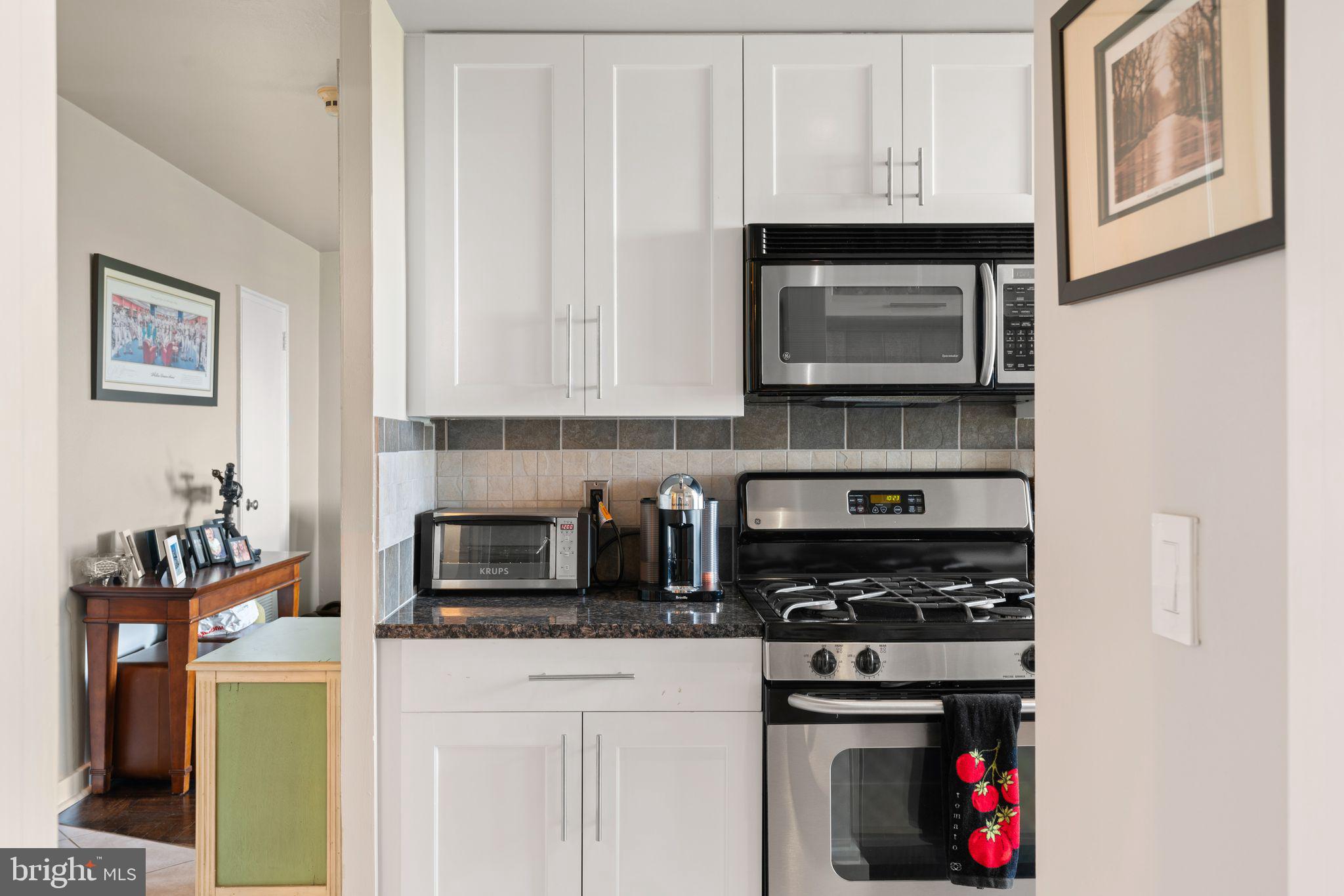 2601 Pennsylvania Avenue, Unit 846 Philadelphia, PA 19130 - Photo 20 of 40 a kitchen with stainless steel appliances granite countertop a stove and a microwave