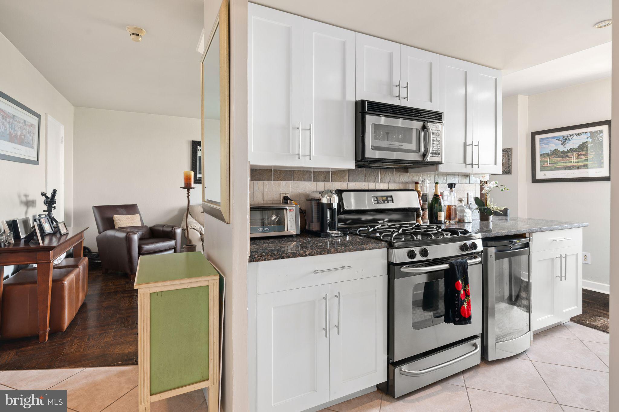 2601 Pennsylvania Avenue, Unit 846 Philadelphia, PA 19130 - Photo 21 of 40 a kitchen with stainless steel appliances granite countertop a stove and a sink